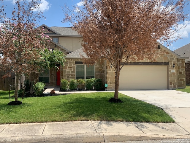 obstructed view of property featuring a garage and a front lawn