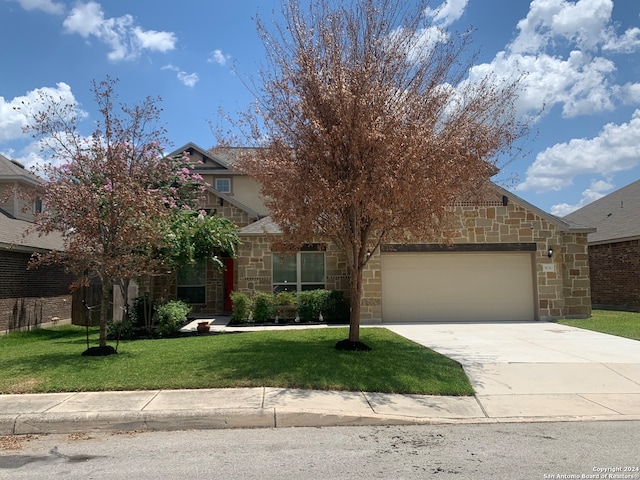 obstructed view of property featuring a garage and a front yard