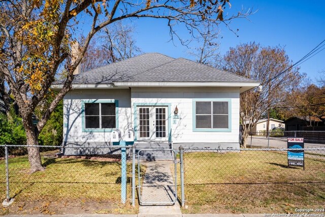 bungalow with french doors and a front yard