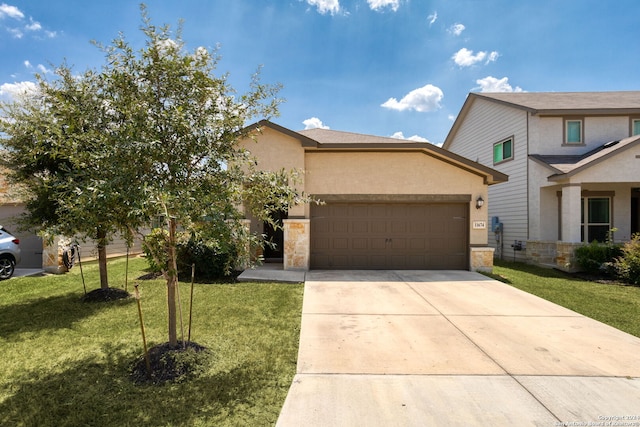 view of front of home with a garage and a front lawn