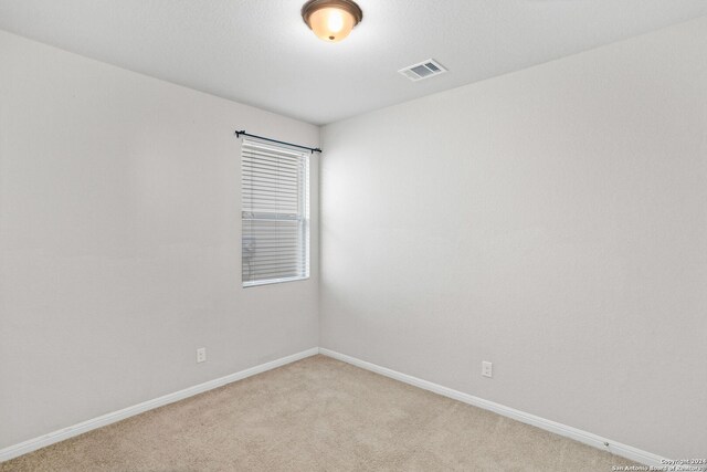 empty room featuring light carpet