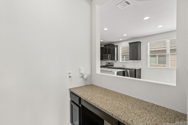 interior space with sink and appliances with stainless steel finishes