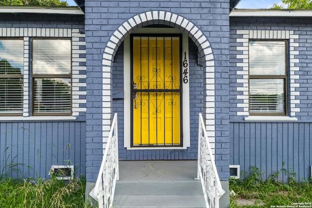 doorway to property with brick siding