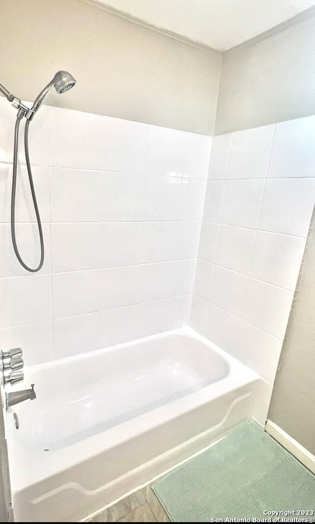 bathroom featuring tile patterned floors and tiled shower / bath combo