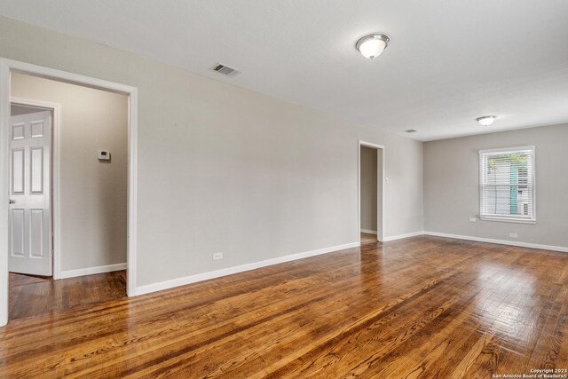 spare room with wood-type flooring