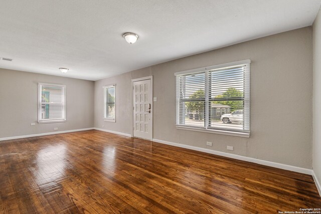 unfurnished room featuring hardwood / wood-style flooring