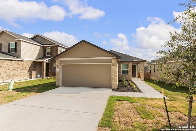 view of front of property with a garage and a front lawn