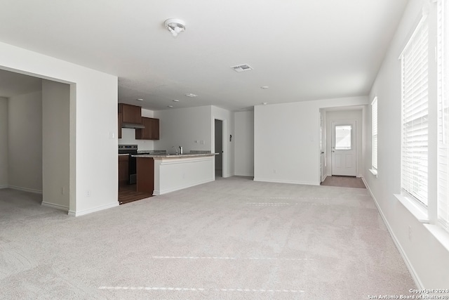 unfurnished living room with light carpet