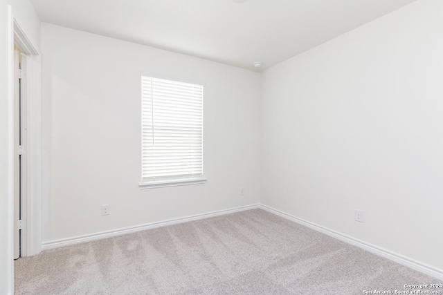 unfurnished room with light carpet