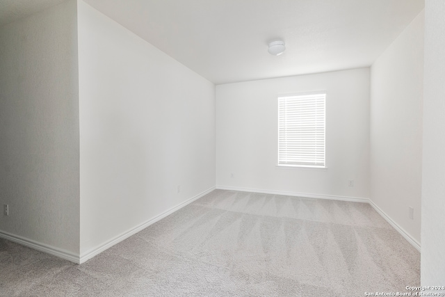 empty room featuring light colored carpet