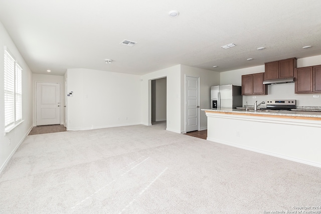 kitchen featuring light colored carpet, sink, and stainless steel appliances