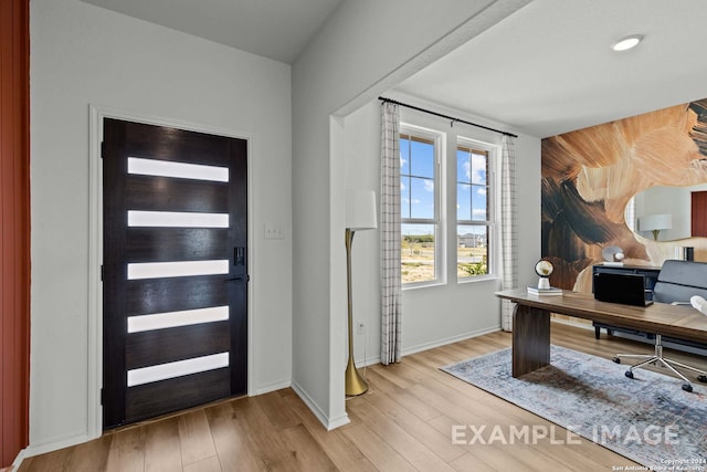 foyer entrance featuring beverage cooler and light hardwood / wood-style flooring