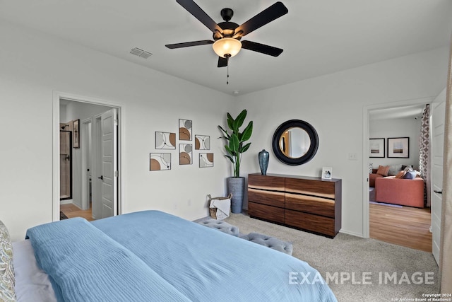 bedroom featuring light carpet and ceiling fan