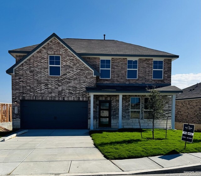 view of front of home featuring a garage and a front yard