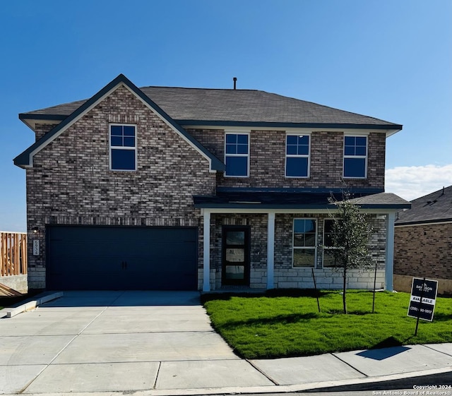 traditional-style home with concrete driveway, brick siding, an attached garage, and a front lawn