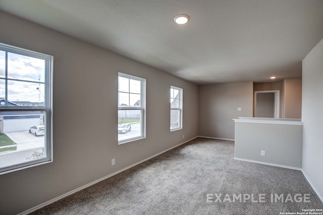 empty room featuring recessed lighting, carpet flooring, and baseboards