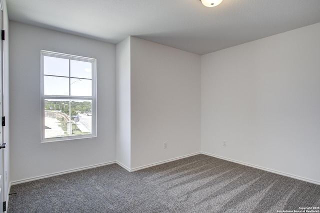 6934 Comanche Cave, San Antonio, TX 78233 - unfurnished room with dark carpet and baseboards