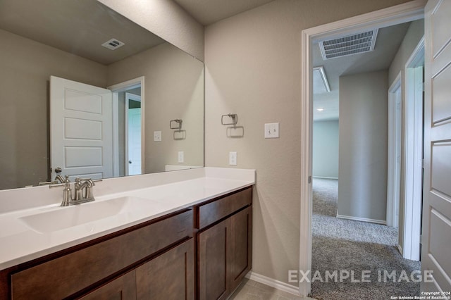 bathroom featuring vanity, visible vents, and baseboards