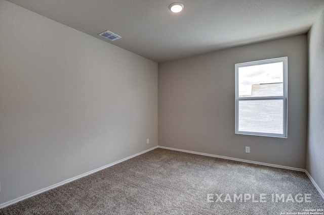 empty room featuring baseboards, visible vents, and carpet flooring