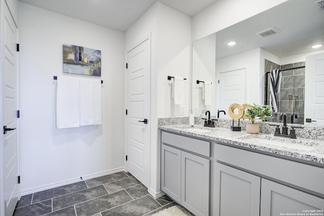 6934 Comanche Cave, San Antonio, TX 78233 - bathroom featuring baseboards, visible vents, a sink, and a stall shower
