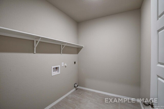 laundry room with washer hookup, hookup for an electric dryer, gas dryer hookup, laundry area, and baseboards