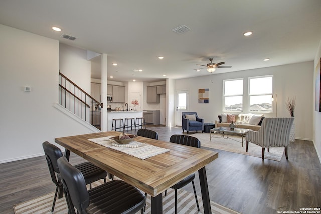 6934 Comanche Cave, San Antonio, TX 78233 - dining room featuring baseboards, visible vents, a ceiling fan, and dark wood-style floors