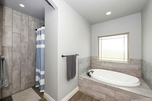 bathroom with hardwood / wood-style floors and shower with separate bathtub