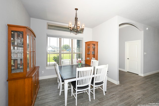 dining room with a chandelier and dark hardwood / wood-style floors