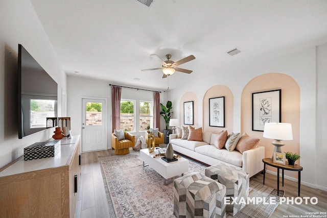 living room featuring light wood-type flooring and ceiling fan