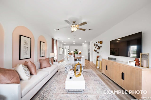 living room featuring light hardwood / wood-style floors and ceiling fan