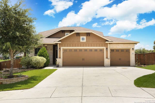 craftsman-style house featuring a garage and a front yard