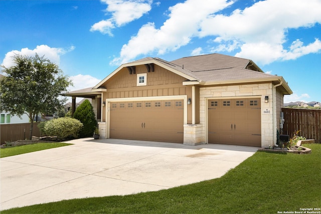 view of front of property featuring a garage and a front yard