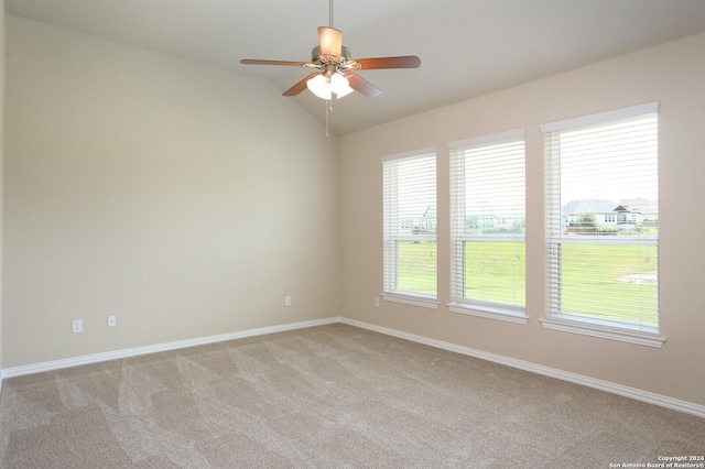 carpeted spare room with lofted ceiling and ceiling fan