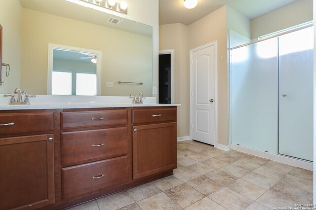 bathroom featuring ceiling fan, walk in shower, tile patterned floors, and dual bowl vanity