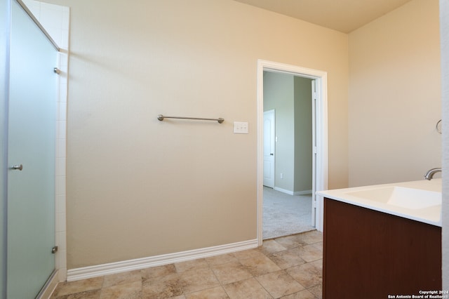 bathroom featuring vanity, an enclosed shower, and tile patterned floors