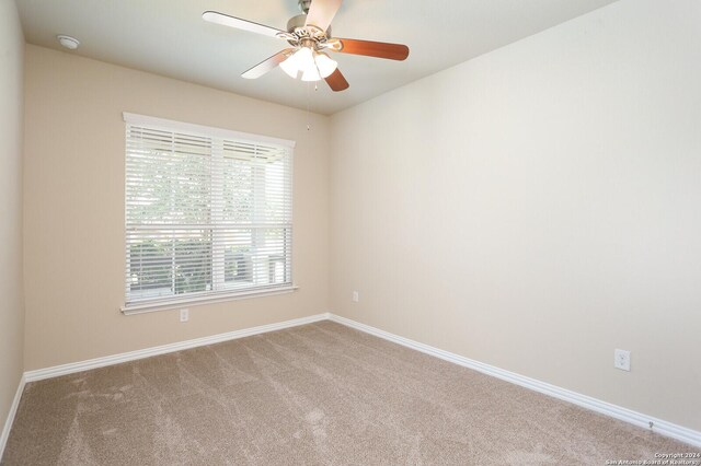 unfurnished room featuring carpet floors and ceiling fan