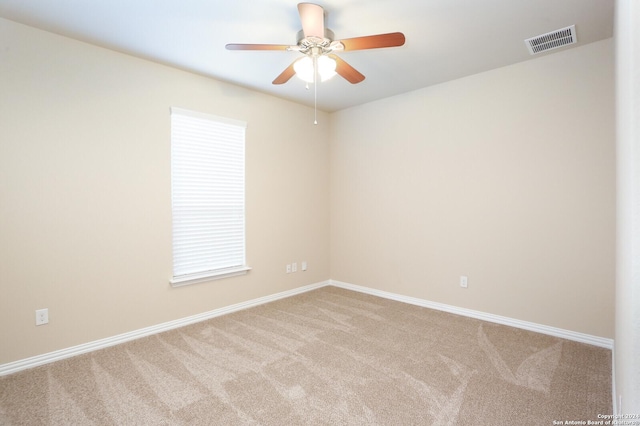 unfurnished room featuring light carpet and ceiling fan