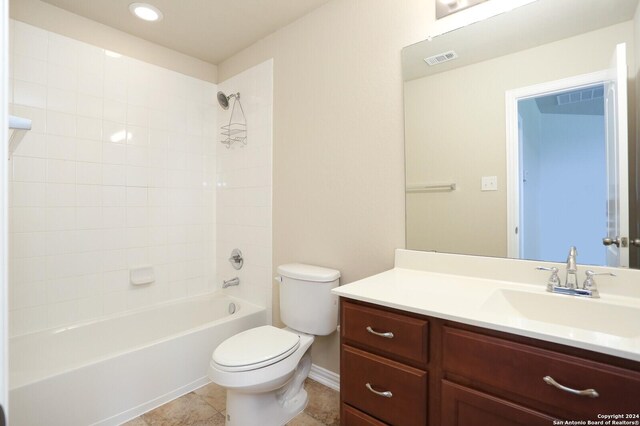 full bathroom with vanity, tiled shower / bath combo, toilet, and tile patterned flooring