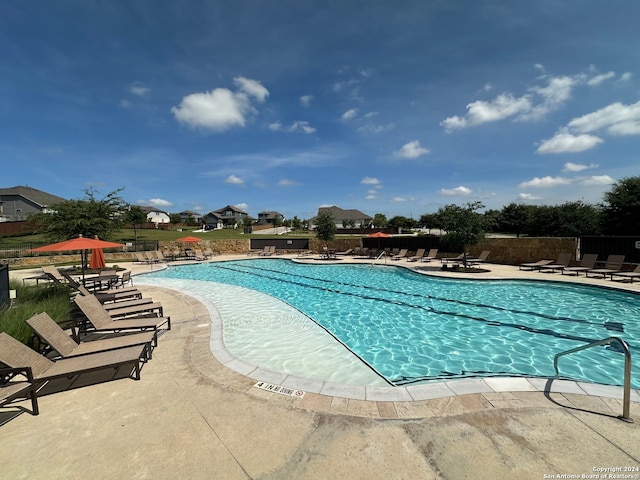 view of swimming pool with a patio area