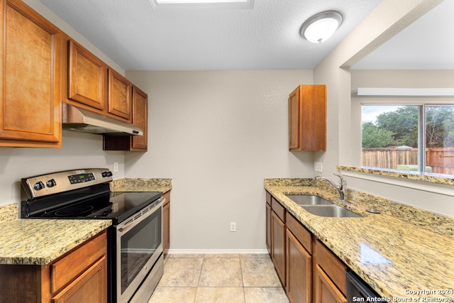 kitchen featuring stainless steel range with electric stovetop, sink, light stone counters, and light tile patterned floors