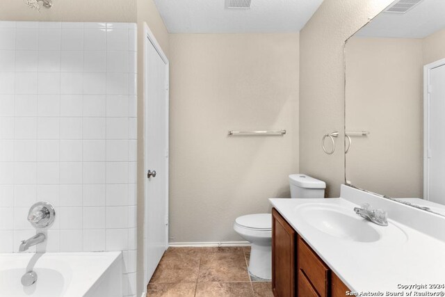 bathroom with vanity, tile patterned flooring, and toilet