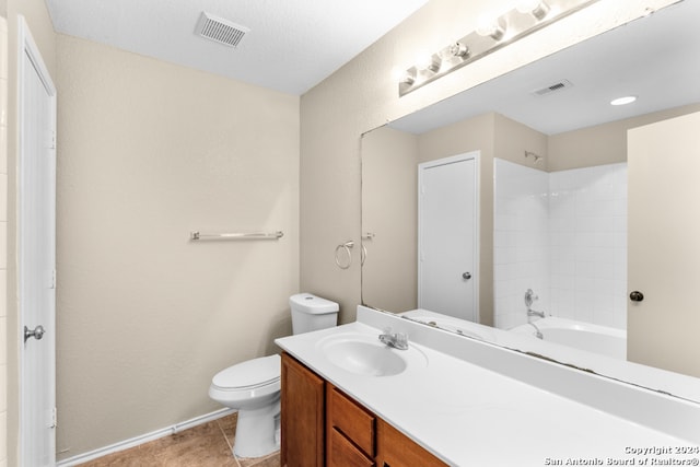 full bathroom featuring vanity, toilet, a textured ceiling, tile patterned flooring, and bathtub / shower combination