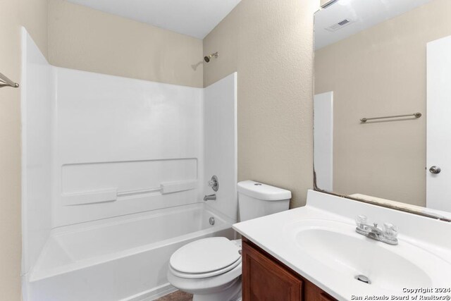 full bathroom featuring tub / shower combination, toilet, and vanity