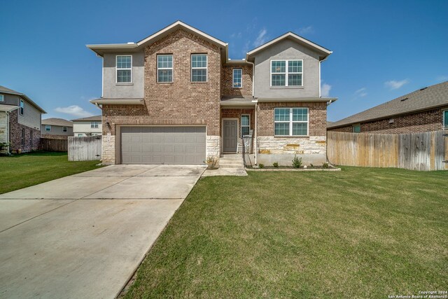 view of front of home featuring a front yard and a garage