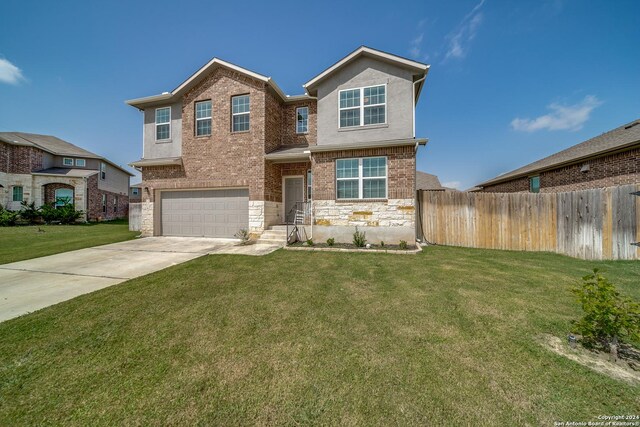 view of front of property with a garage and a front yard