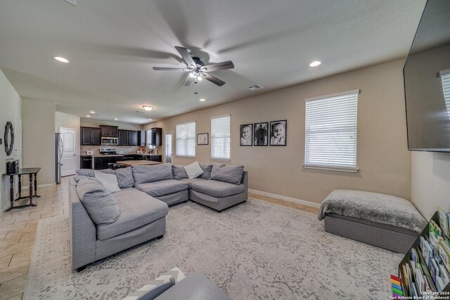 tiled living room featuring ceiling fan