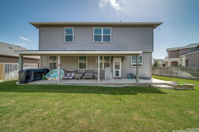 rear view of house featuring a yard and a patio area