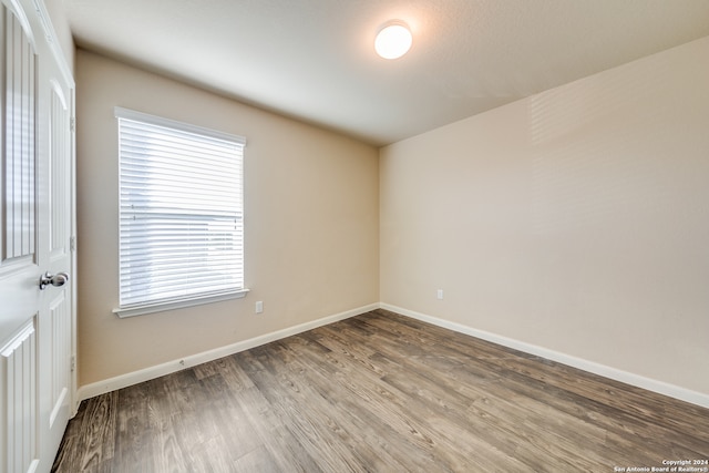 empty room with hardwood / wood-style floors