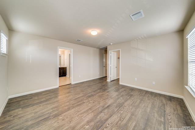 unfurnished room with dark hardwood / wood-style floors