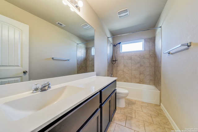 full bathroom with tiled shower / bath, tile patterned floors, toilet, and vanity